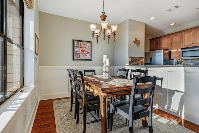 dining room featuring dark wood-type flooring and a chandelier