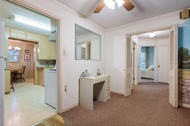 hall with an inviting chandelier, wood walls, light colored carpet, and a textured ceiling