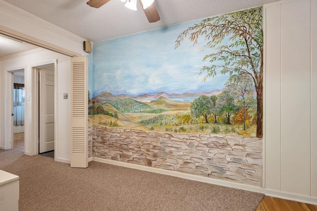 interior space with a closet, ceiling fan, and a textured ceiling