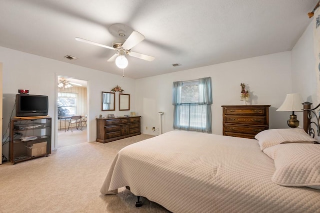 bedroom featuring light carpet and ceiling fan