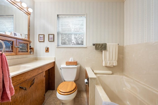 bathroom featuring toilet, a tub, tile patterned floors, and a healthy amount of sunlight