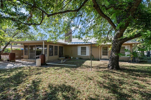 back of house with a lawn