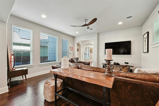 living room featuring ceiling fan and dark wood-type flooring