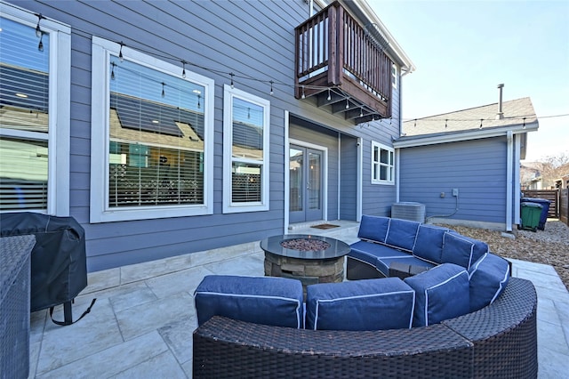 view of patio / terrace featuring a balcony, grilling area, and an outdoor living space with a fire pit