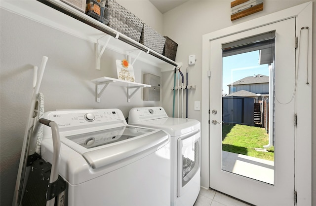 laundry area featuring light tile patterned flooring and separate washer and dryer