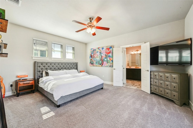 bedroom with ceiling fan, connected bathroom, and carpet floors