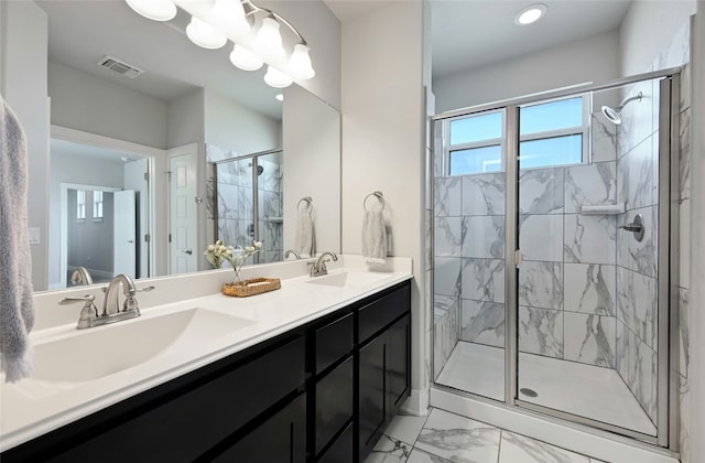 bathroom featuring vanity and a shower with door