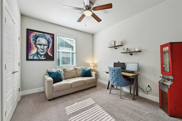 carpeted home office featuring ceiling fan