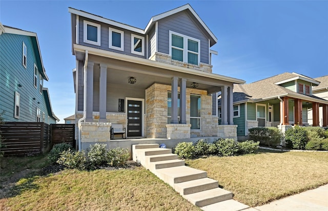 craftsman-style home featuring a porch and a front lawn