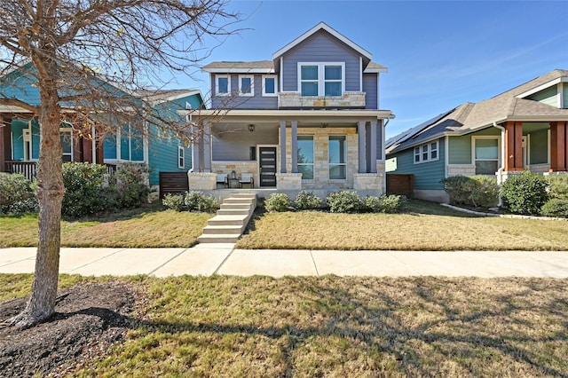 craftsman-style home with a front yard and a porch