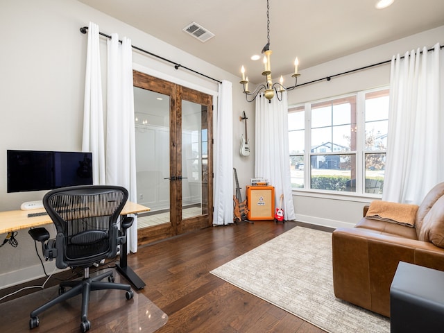 office space with dark wood-type flooring, a chandelier, and french doors