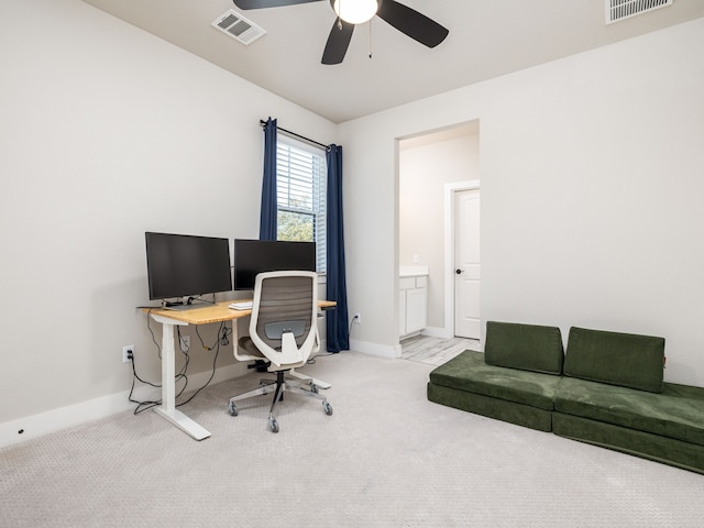 office area featuring ceiling fan and light carpet