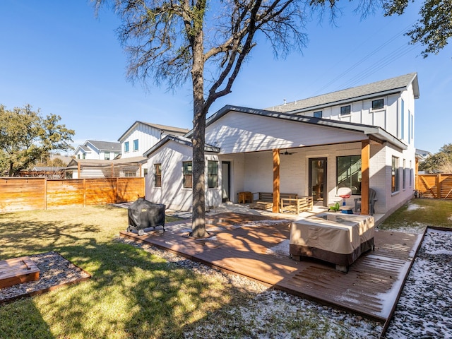 rear view of house with a lawn and a deck