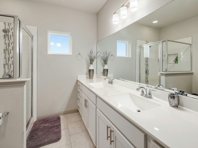 bathroom featuring vanity, a shower with shower door, and tile patterned flooring