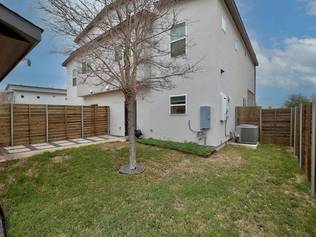 back of house featuring cooling unit and a yard