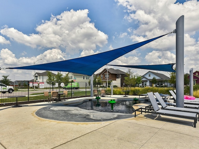 view of community featuring a swimming pool and a patio