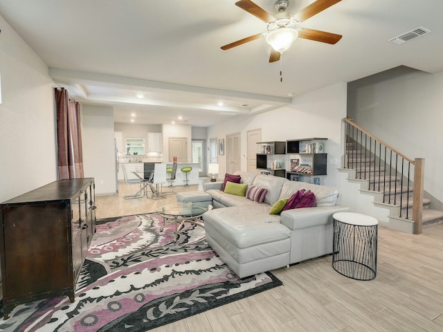 living room with ceiling fan and light wood-type flooring