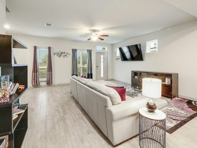 living room featuring light hardwood / wood-style floors and ceiling fan