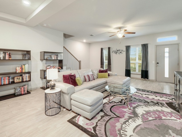 living room featuring light hardwood / wood-style floors and ceiling fan