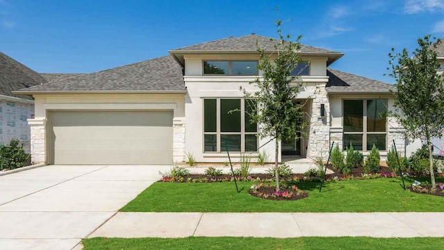 1716 Snowdrop Dr, Georgetown, TX 78628 - prairie-style house featuring stucco siding, a shingled roof, a garage, driveway, and a front lawn