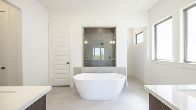 1716 Snowdrop Dr, Georgetown, TX 78628 - bathroom featuring vanity, a stall shower, a soaking tub, and tile patterned floors