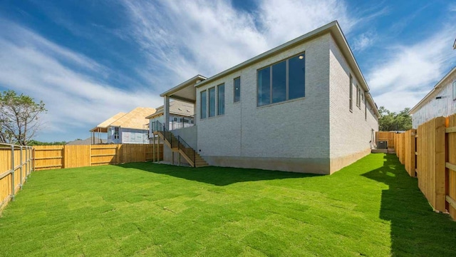 1716 Snowdrop Dr, Georgetown, TX 78628 - rear view of property with brick siding, stairs, and a fenced backyard