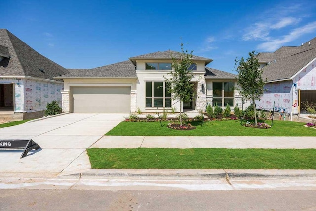 1716 Snowdrop Dr, Georgetown, TX 78628 - view of front of home featuring an attached garage, driveway, a front yard, stucco siding, and stone siding