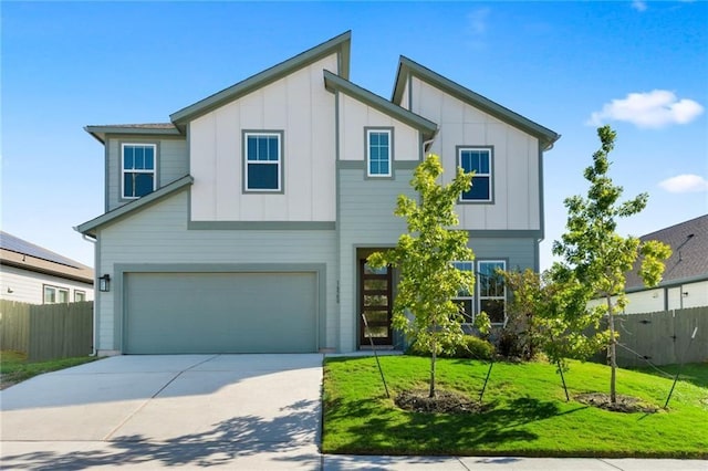 view of front of property with a garage and a front lawn