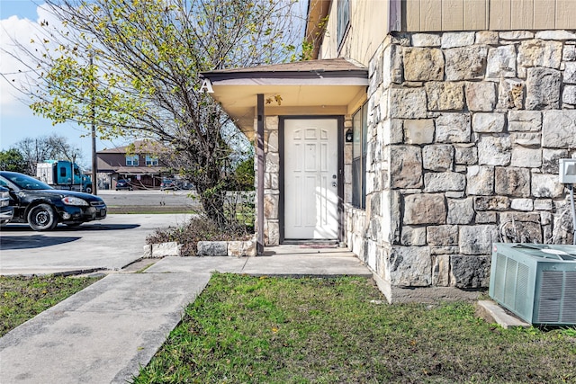 view of exterior entry with central AC unit