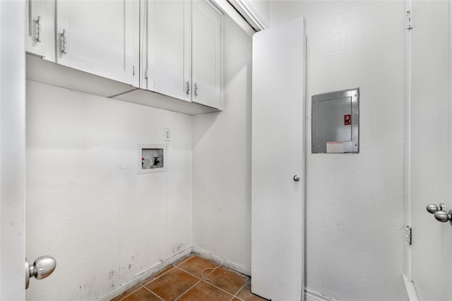 laundry room featuring washer hookup, electric panel, dark tile patterned floors, and cabinets