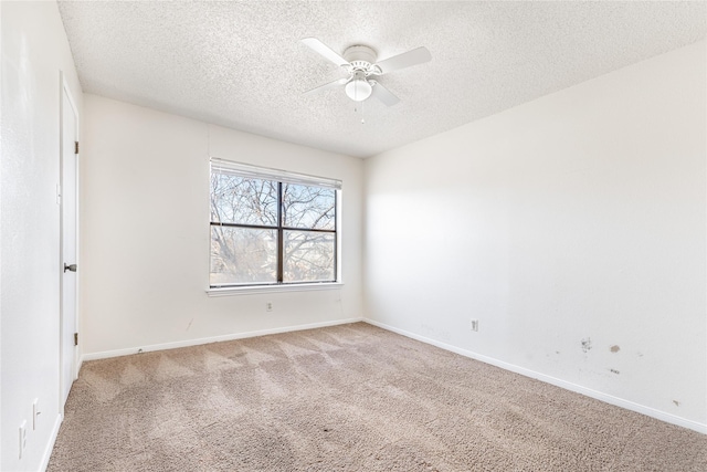 carpeted spare room with ceiling fan and a textured ceiling