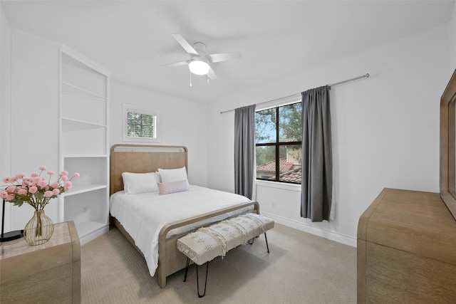 bedroom with ceiling fan and light colored carpet