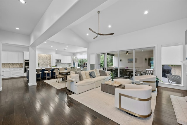 living room with high vaulted ceiling, dark hardwood / wood-style floors, and ceiling fan