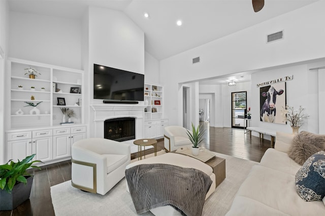 living room featuring hardwood / wood-style flooring and high vaulted ceiling