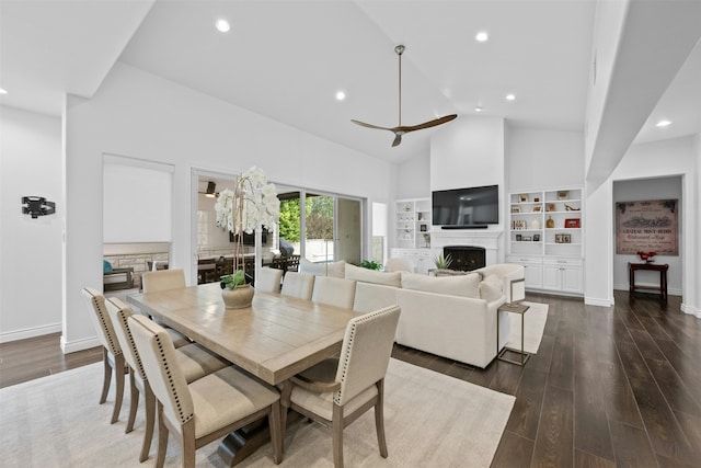 dining area with dark wood-type flooring, high vaulted ceiling, and ceiling fan