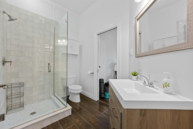 bathroom with vanity, toilet, and an enclosed shower