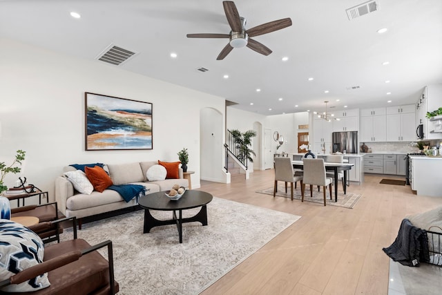 living room featuring ceiling fan and light wood-type flooring