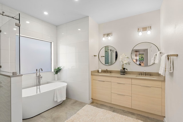 bathroom with vanity, concrete flooring, and a tub