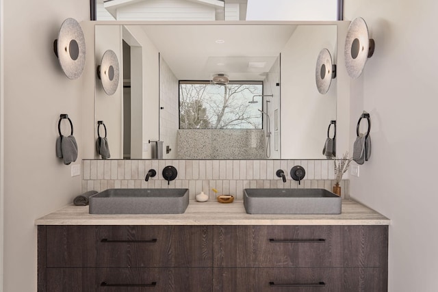 bathroom featuring vanity, decorative backsplash, and an enclosed shower