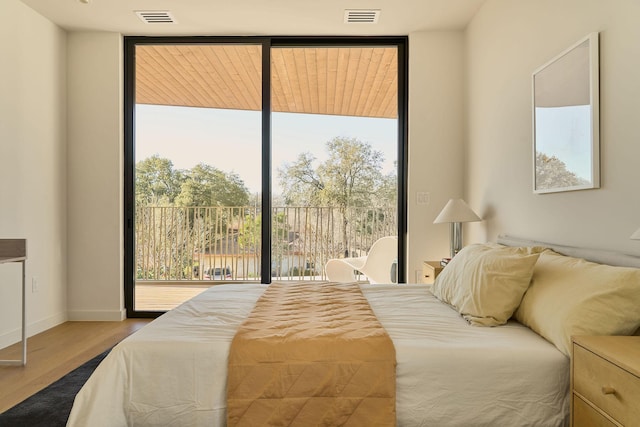 bedroom featuring hardwood / wood-style floors and access to outside