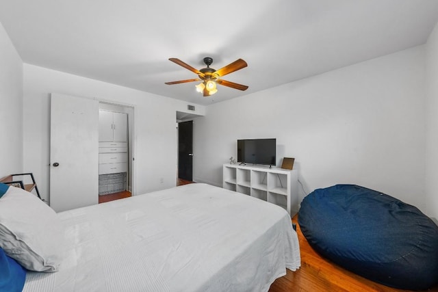 9009 N Plz Unit 118, Austin, TX 78753 - bedroom featuring wood finished floors and a ceiling fan