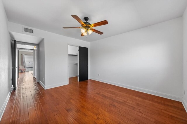 9009 N Plz Unit 118, Austin, TX 78753 - unfurnished bedroom featuring baseboards, wood finished floors, a closet, and a ceiling fan