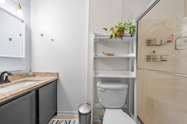 9009 N Plz Unit 118, Austin, TX 78753 - full bathroom featuring vanity, toilet, a stall shower, and baseboards
