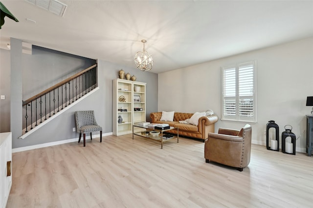 living room featuring an inviting chandelier and light wood-type flooring