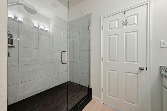 bathroom featuring vanity and an enclosed shower