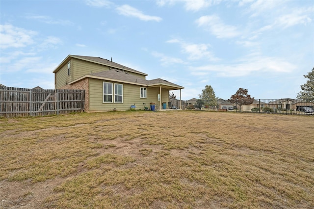 rear view of property featuring a yard