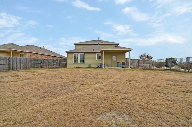 rear view of property with a lawn