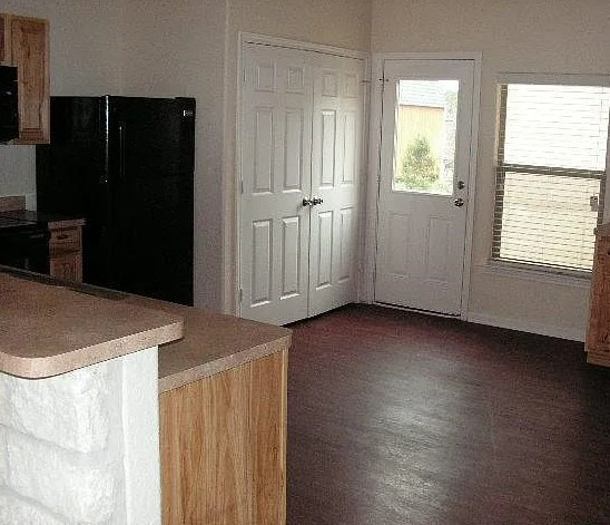 kitchen with black refrigerator and stove