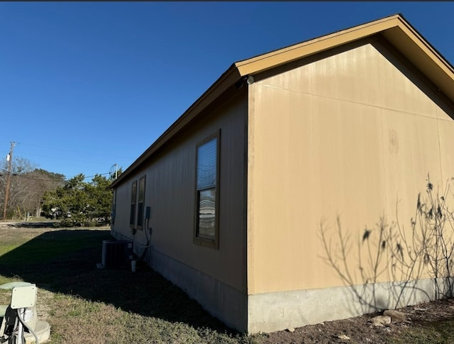 view of side of home featuring central AC unit