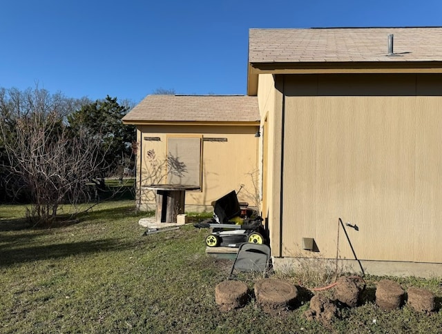 view of outbuilding with a lawn